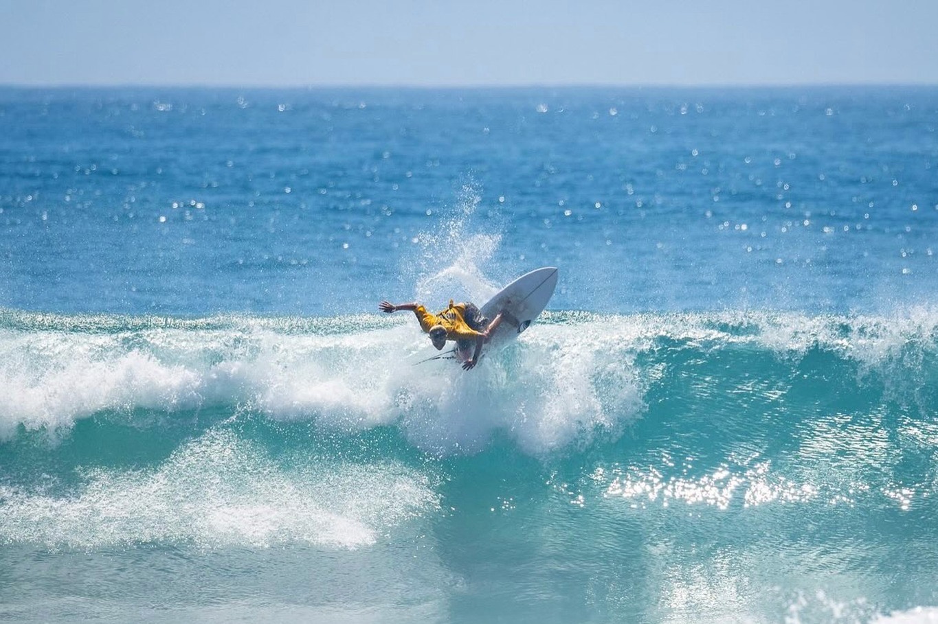 Young surfer launching an air off a wave
