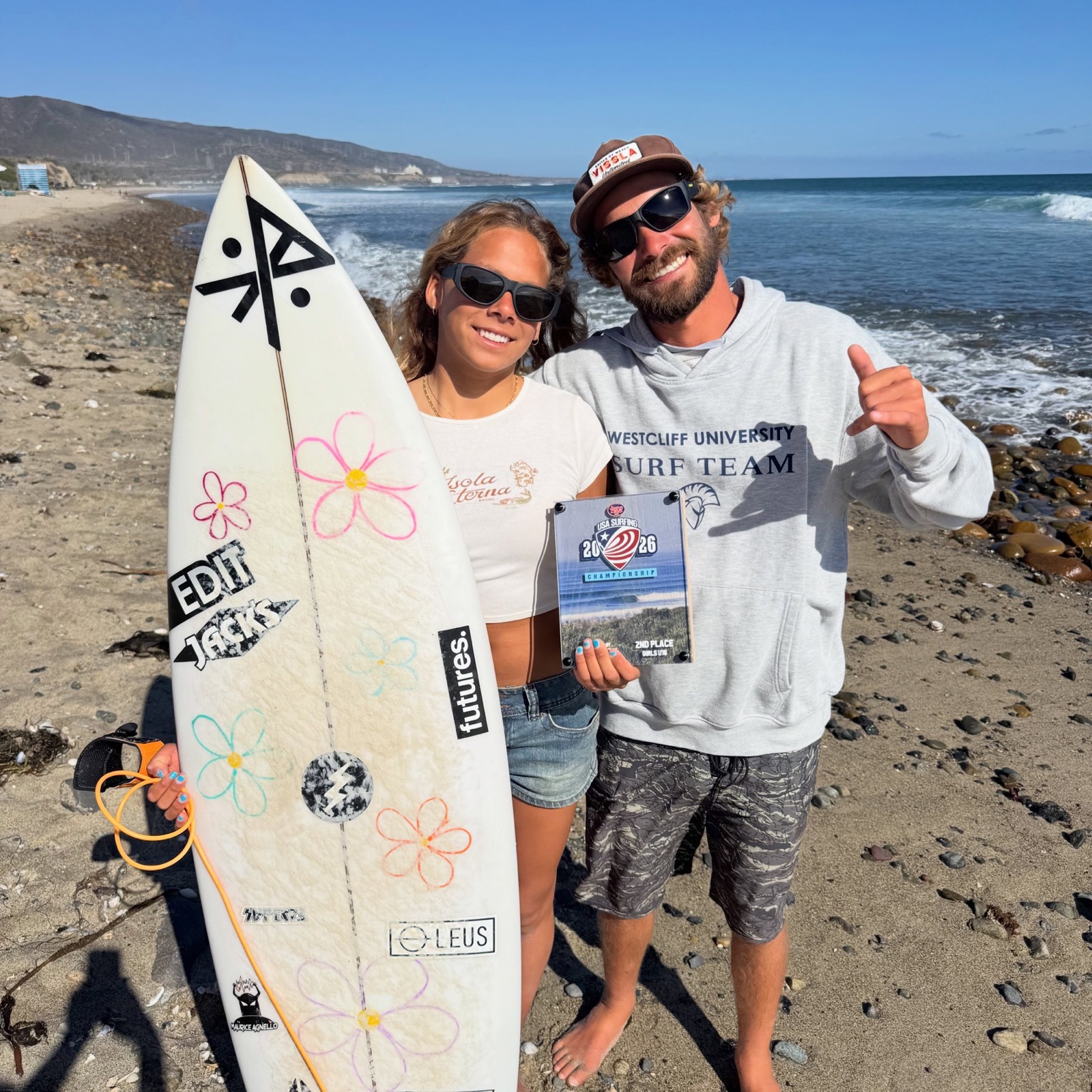 Lucas with a Westcliff University surfer and her contest award
