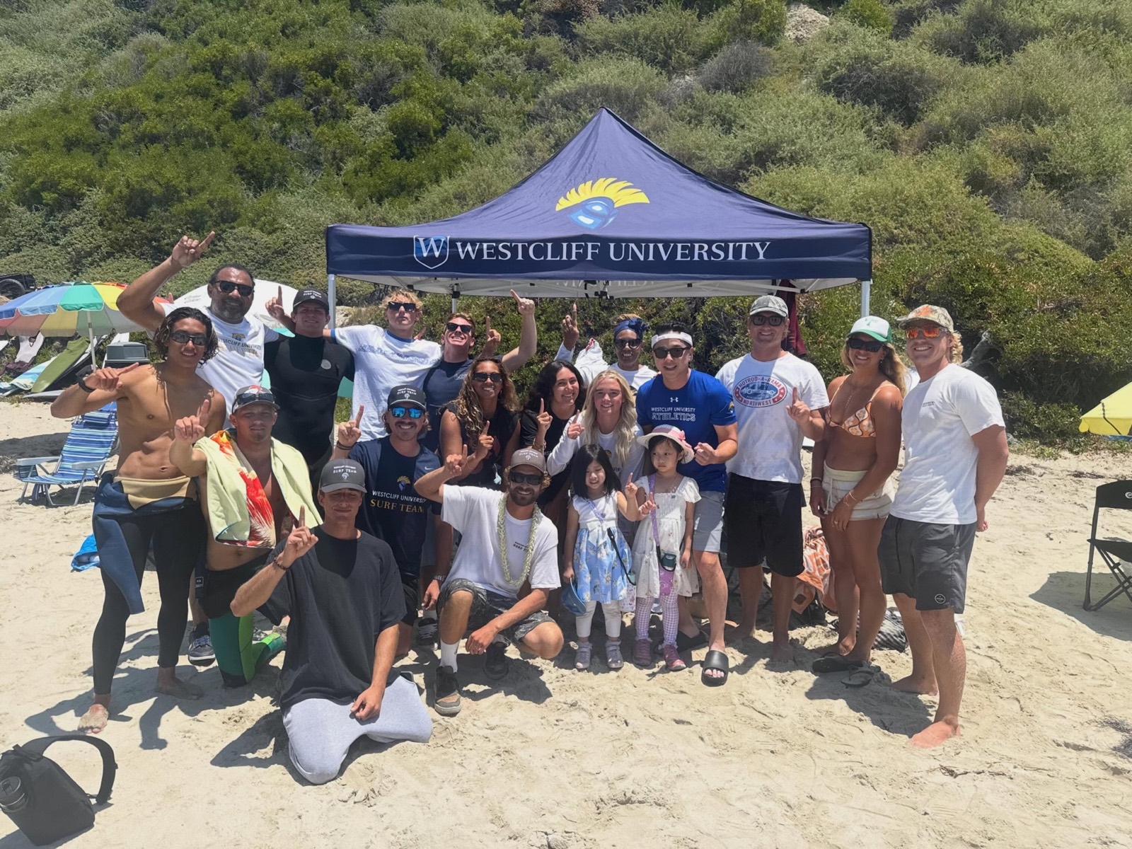 The Westcliff University surf team under their tent at a contest